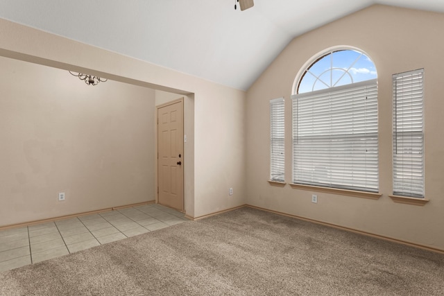 carpeted spare room with vaulted ceiling and ceiling fan