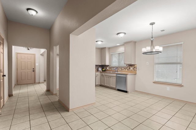 kitchen with dishwasher, white cabinets, a chandelier, decorative backsplash, and hanging light fixtures