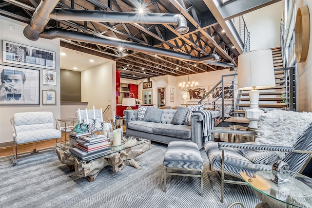 living room featuring a towering ceiling and an inviting chandelier