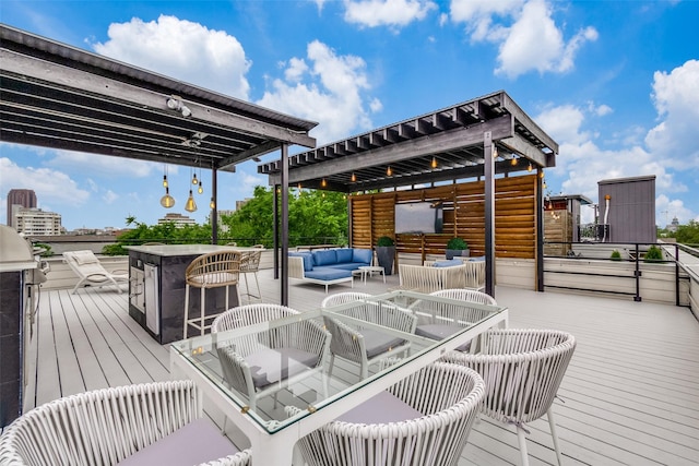 wooden terrace with an outdoor hangout area and a bar