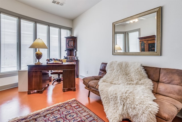 office with plenty of natural light and concrete floors