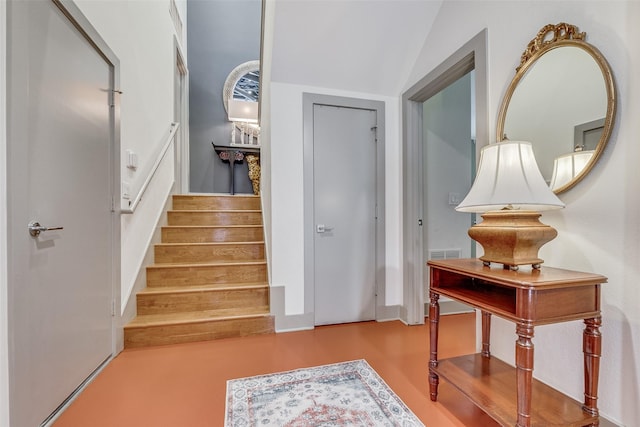 staircase featuring lofted ceiling