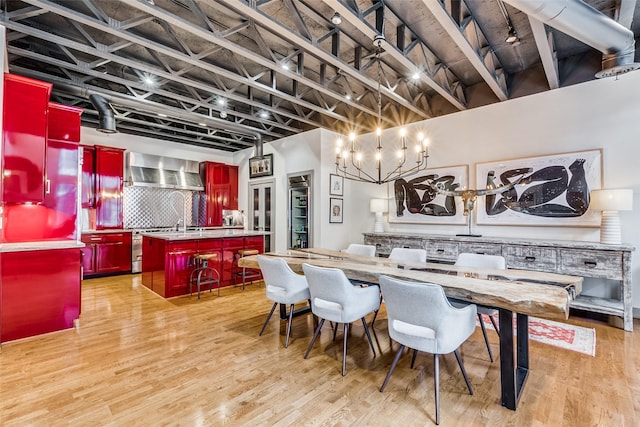 dining space with an inviting chandelier and light hardwood / wood-style floors