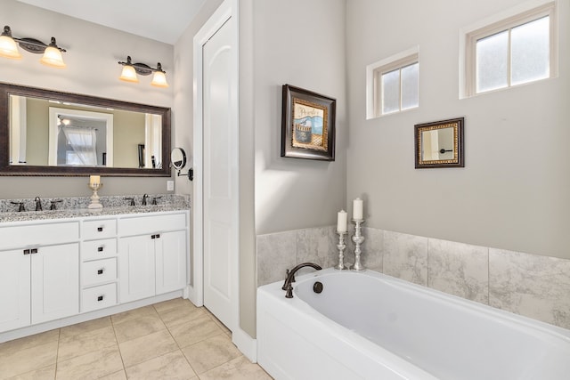 bathroom with vanity, tile patterned floors, and a tub