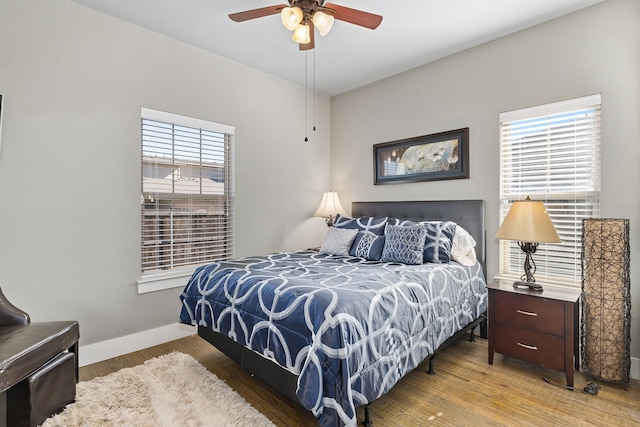 bedroom with hardwood / wood-style flooring and ceiling fan