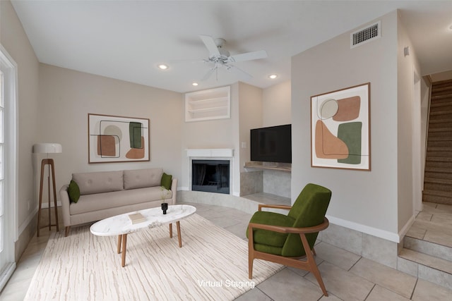 living room with ceiling fan and light tile patterned flooring