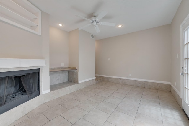 unfurnished living room with ceiling fan and light tile patterned floors