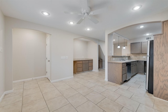 kitchen featuring pendant lighting, sink, decorative backsplash, ceiling fan, and stainless steel appliances