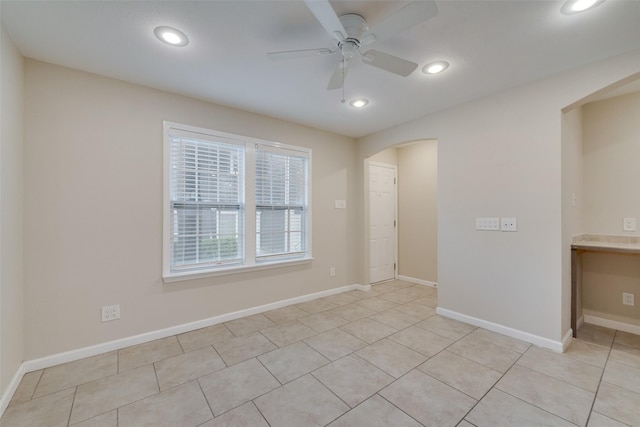 unfurnished room with light tile patterned floors and ceiling fan