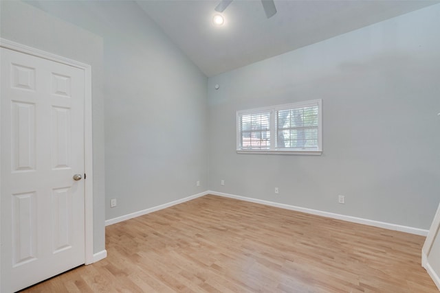 spare room with ceiling fan, lofted ceiling, and light hardwood / wood-style floors