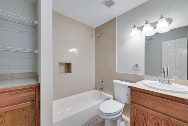 full bathroom with vanity, tiled shower / bath combo, and toilet