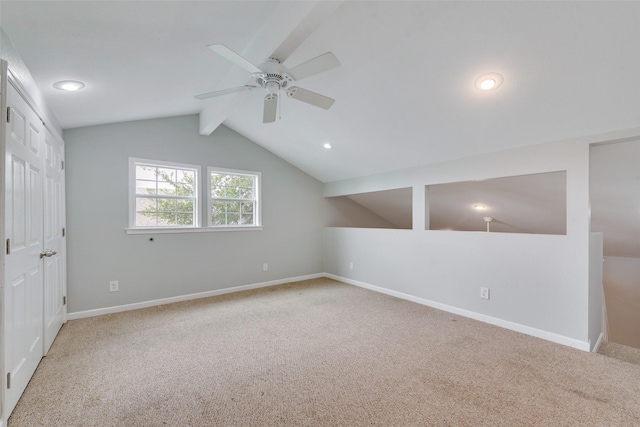 bonus room with lofted ceiling with beams, ceiling fan, and carpet