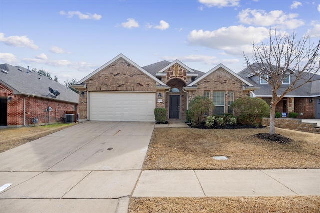 front of property with a garage and central AC unit