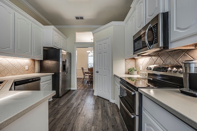 kitchen featuring dark hardwood / wood-style floors, white cabinetry, decorative backsplash, ornamental molding, and stainless steel appliances