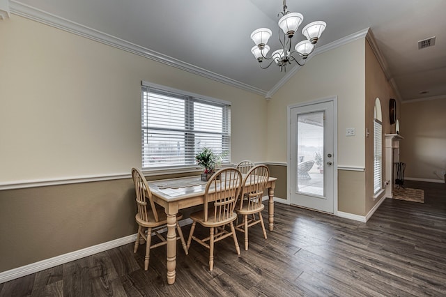 dining space with ornamental molding, dark hardwood / wood-style floors, a chandelier, and vaulted ceiling