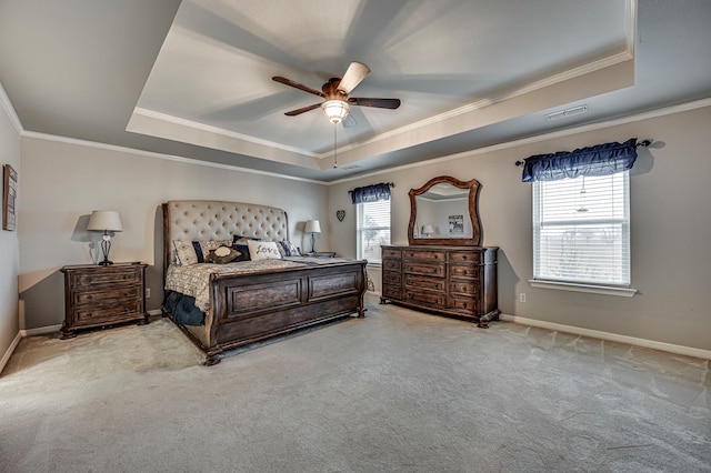 carpeted bedroom with crown molding, a raised ceiling, and ceiling fan