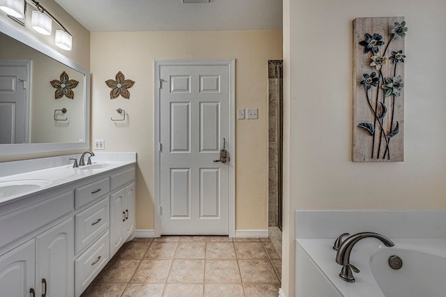 bathroom with tile patterned flooring, vanity, and a bathing tub