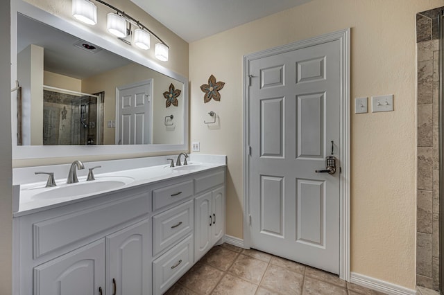 bathroom featuring vanity, tile patterned flooring, and walk in shower