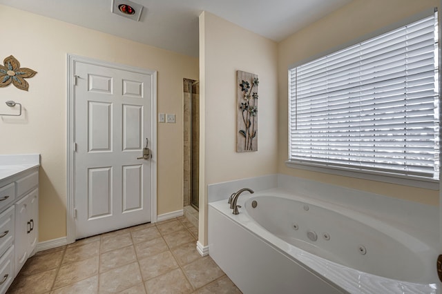 bathroom with tile patterned floors, vanity, and separate shower and tub