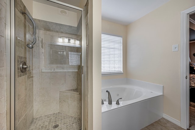 bathroom featuring independent shower and bath