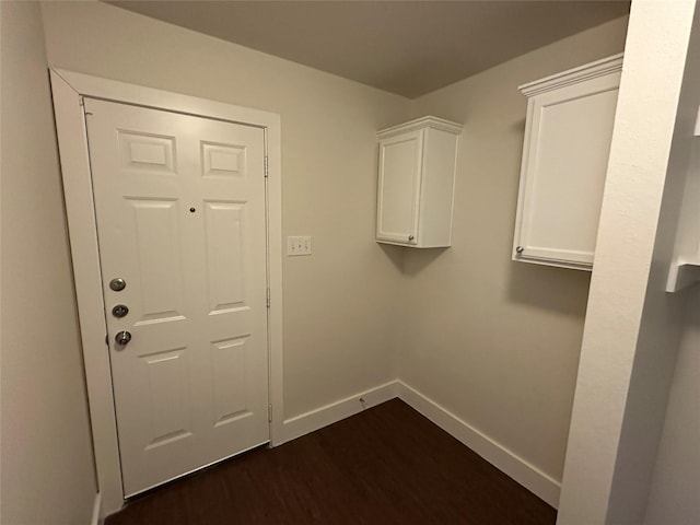 clothes washing area with dark hardwood / wood-style flooring