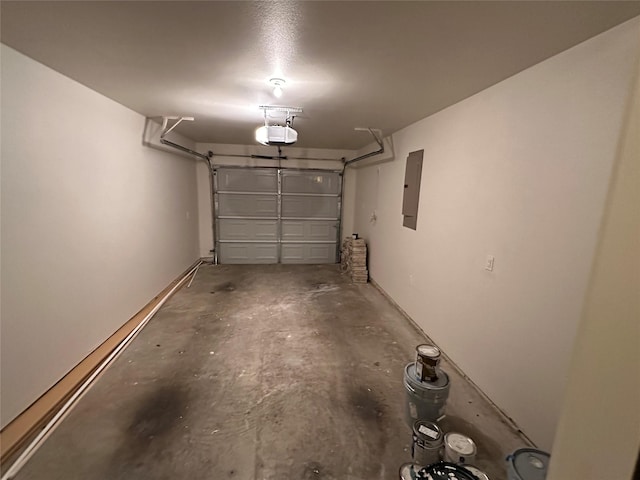 garage with a garage door opener and electric panel