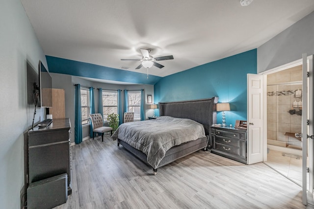 bedroom featuring ceiling fan, vaulted ceiling, and light wood-type flooring