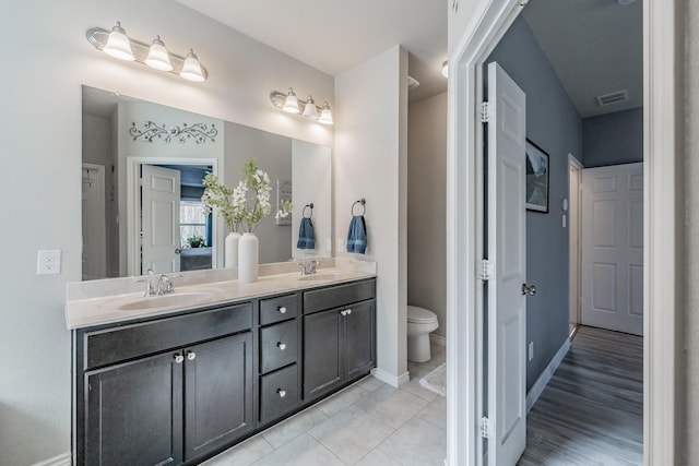 bathroom with tile patterned floors, vanity, and toilet