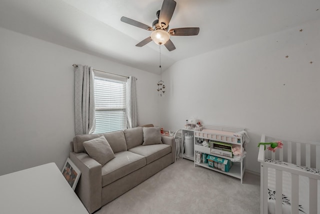 living room with ceiling fan, light colored carpet, and vaulted ceiling