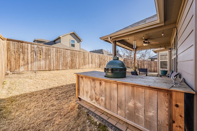 view of patio featuring ceiling fan and a grill