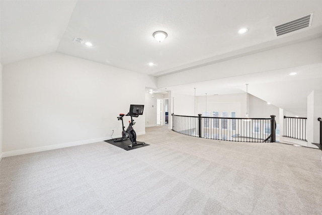 exercise room featuring lofted ceiling and light carpet