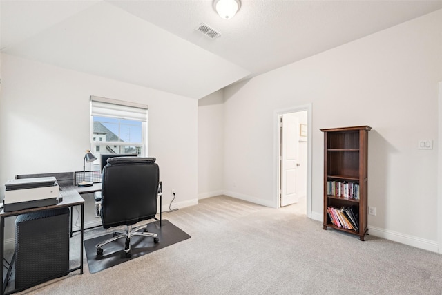 office area featuring lofted ceiling and light carpet