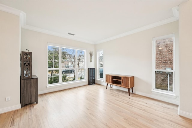 unfurnished living room with crown molding and light wood-type flooring