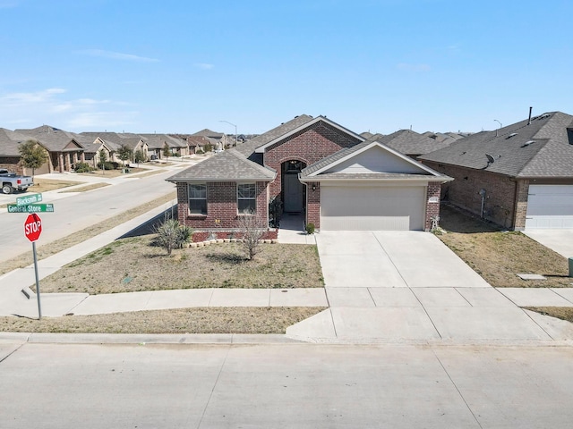 ranch-style house with a garage, brick siding, concrete driveway, roof with shingles, and a residential view