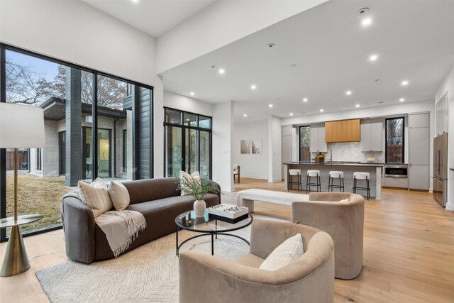 kitchen with dark countertops, appliances with stainless steel finishes, a sink, tasteful backsplash, and modern cabinets