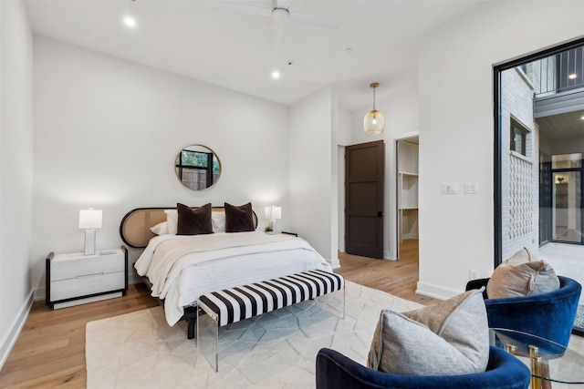 bedroom with ceiling fan, access to exterior, and light wood-type flooring