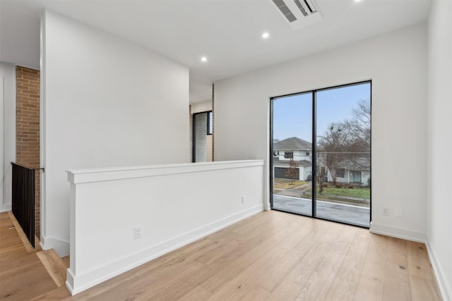 spare room featuring light hardwood / wood-style flooring