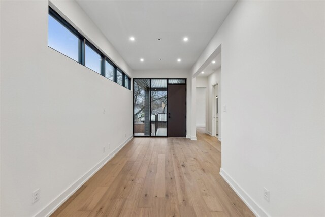 unfurnished room with visible vents, recessed lighting, baseboards, and wood finished floors