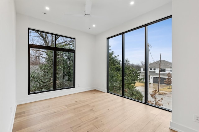 unfurnished room with ceiling fan and light hardwood / wood-style flooring