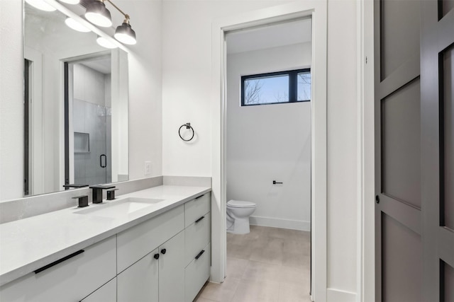 bathroom with an enclosed shower, vanity, and toilet