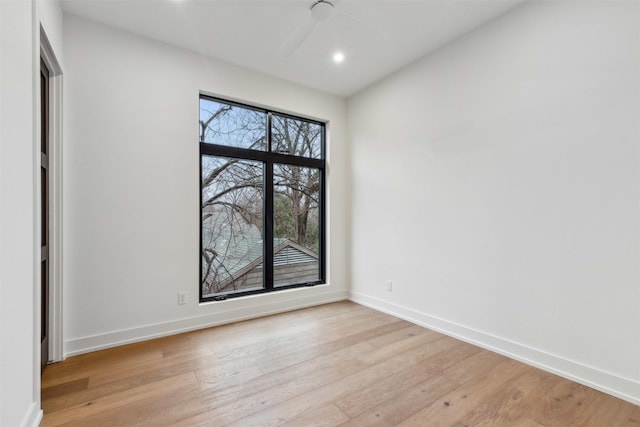 spare room featuring light hardwood / wood-style floors and ceiling fan