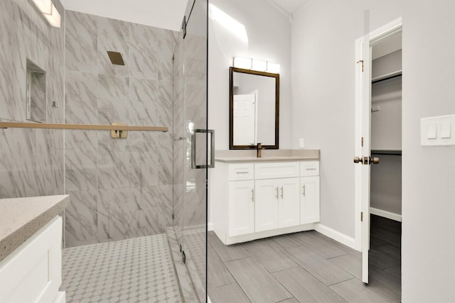 bathroom with vanity and a shower with shower door