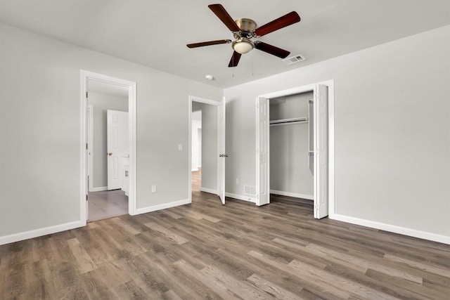 unfurnished bedroom with ceiling fan, hardwood / wood-style floors, and a closet