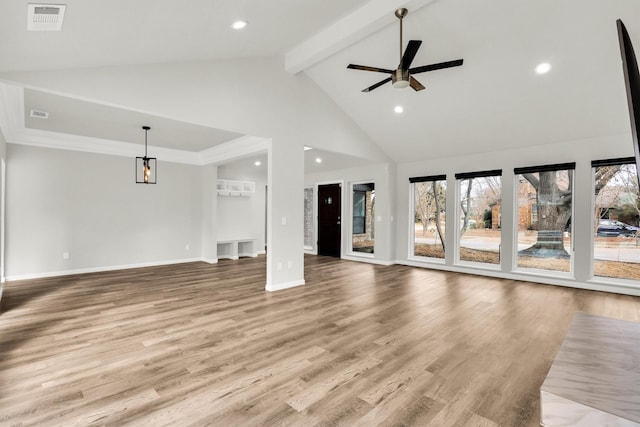 unfurnished living room featuring beam ceiling, high vaulted ceiling, ceiling fan, and light wood-type flooring