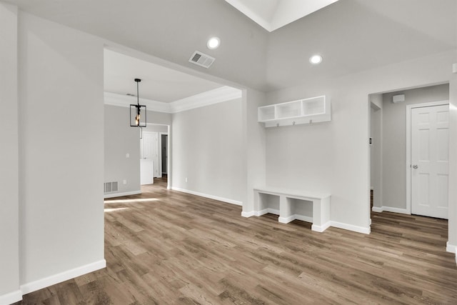 interior space featuring wood-type flooring and ornamental molding