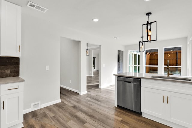 kitchen with sink, hardwood / wood-style flooring, dishwasher, white cabinetry, and decorative light fixtures