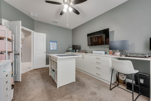 carpeted office space with lofted ceiling and ceiling fan