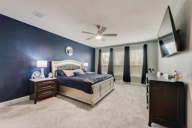 bedroom featuring ceiling fan and light carpet