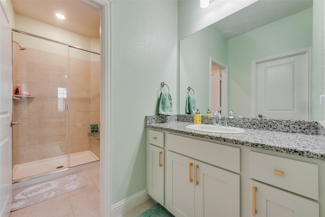 bathroom with tile patterned floors, vanity, and an enclosed shower