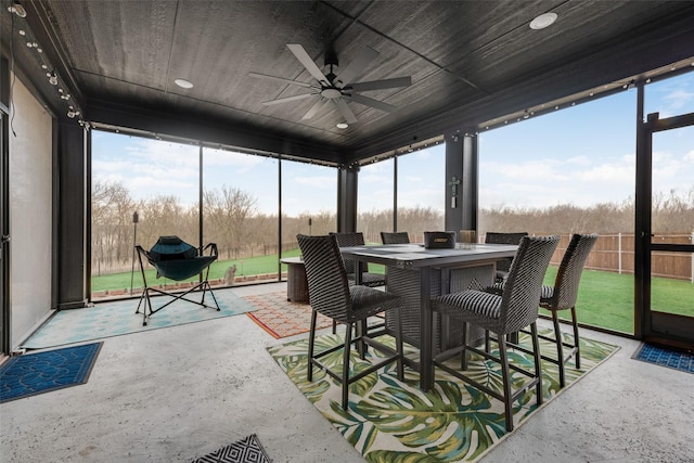 sunroom / solarium featuring wooden ceiling and ceiling fan